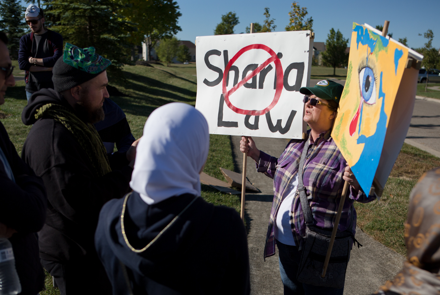 woman protests against "Sharia Law" outside Islamic center