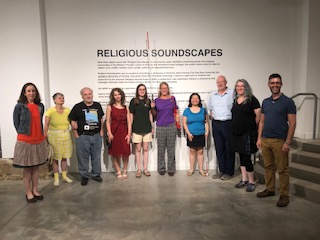 Group standing in front of the introductory wall at Religious Soundscapes
